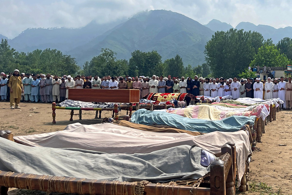 Mourners offer funeral prayers for victims of flash floods in Buner district in northern Pakistan's mountainous Khyber Pakhtunkhwa province on August 16, 2025. (Photo by Aziz Buneri / AFP)