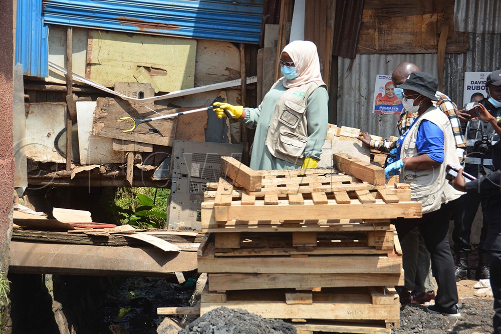 The KCCA executive director, Hajat Sharifah Buzeki (left), inspects the drainage channel at Usafil Market during the cleaning exercise at Kisenyi III in Kampala on Saturday, November 29, 2025. (Photo by Francis Emorut)