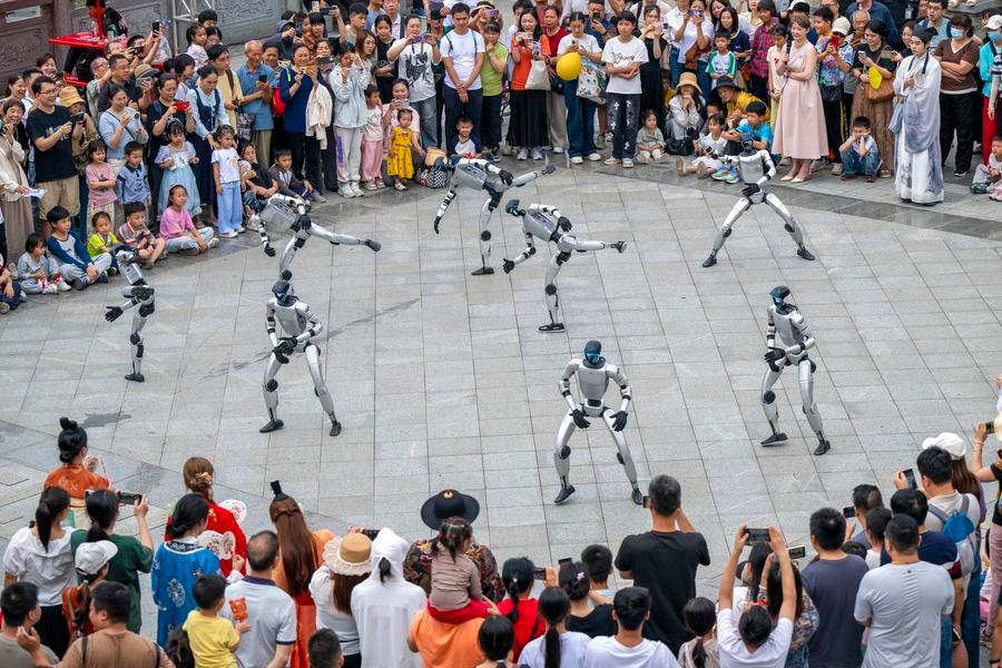A drone photo taken on May 2, 2026 shows robots performing at a park during the ongoing May Day holiday in Wuzhou City, south China's Guangxi Zhuang Autonomous Region. (Photo by He Huawen/Xinhua)