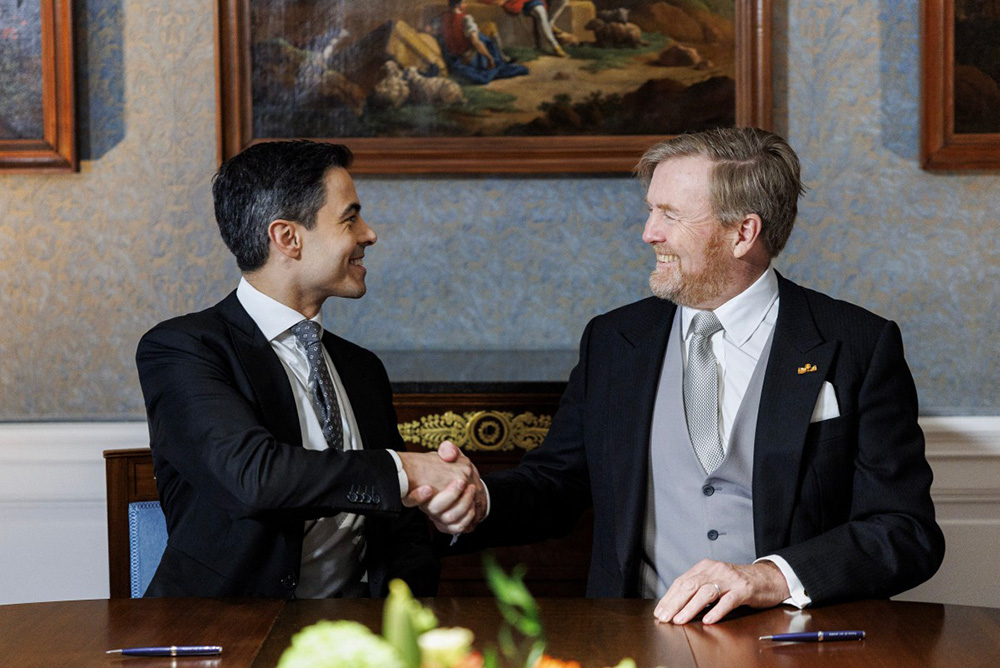 Netherlands' King Willem-Alexander (R) shakes hands with Prime Minister Rob Jetten during the signing of the Royal Decrees in the Meeting Room at Huis ten Bosch Palace for the swearing-in ceremony of the new cabinet in The Hague, The Netherlands on February 23, 2026. (Photo by Koen van Weel / ANP / AFP)