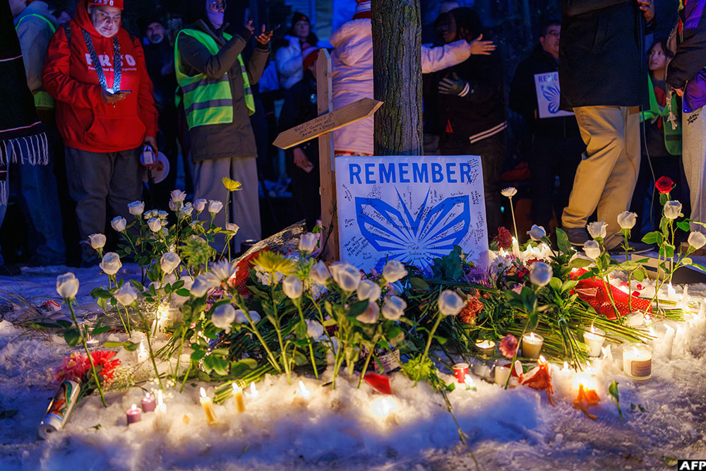 People demonstrate during a vigil at the site where a woman was shot and killed by an immigration officer in Minneapolis, Minnesota, on January 7, 2026