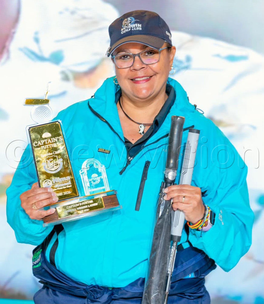 Venessa Peris poses with the Captains Putter tournament prizes in Entebbe. (Courtesy photo)