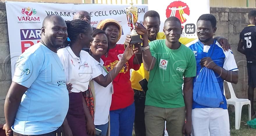 Executive Director VARAM sickle cell Vicky Irebu (2nd left) celebrating the trophy with Etop radio staff. (Credit: Juliet Akello)