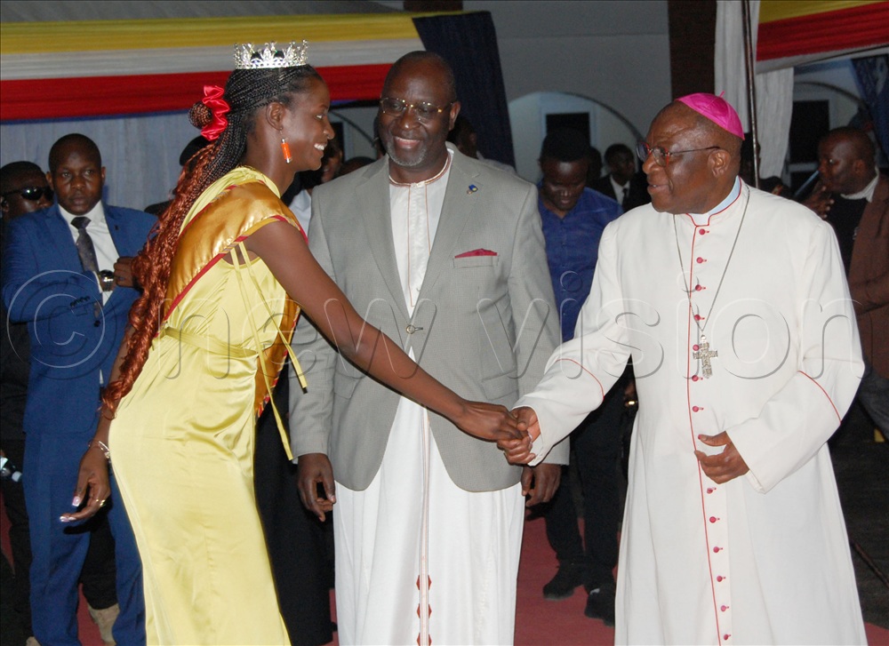Miss Tourism Uganda, Nachap Cindy Kezia (left) shares a moment with Archbishop Paul Ssemogerere (right) and the Deputy Katikkiro of Buganda Robert Wagwa Nsibirwa (centre) during the commissioning of Kabaka Muteesa I Catholic Memorial Museum on October 25.