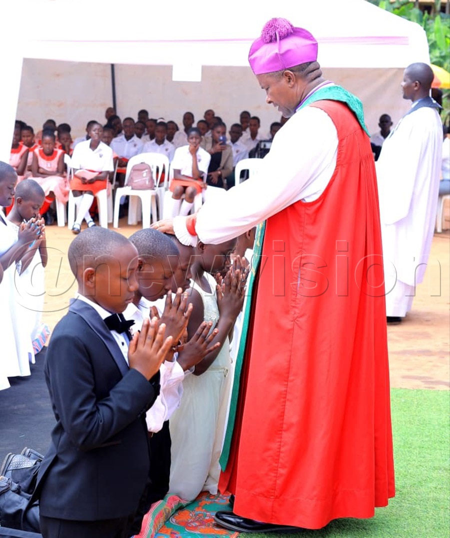 Bishop Enos Kitto Kagodo confirms pupils of St. Abel Primary School in Njeru into the Anglican faith