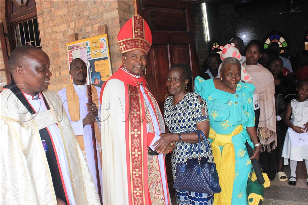 Bp. Kagodo greets Christians after the Easter service at Mukono Cathedral. Looking on (left) is the Provost, Rev. Canon Godfrey Ssengendo.