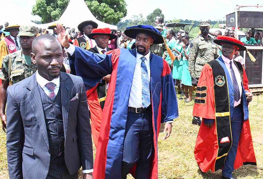 The Kyabazinga of Busoga, William Gabula Nadiope IV (C) waves to his subjects on his arrival at the 3rd graduation ceremony of Lubega Institute of Nursing and Health Professionals in Iganga district on Friday. Looking on is the proprietor of the Institute and UMSC's chairman Prof. Dr Muhamadi Lubega (R). (All Photos by Donald Kiirya)