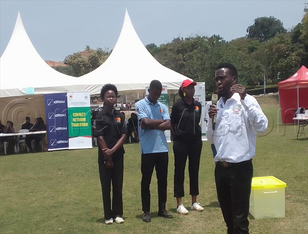 The Mastercard Scholars, led by the chairperson Give Back Committee Alex Muhangi, deliver remarks about their latest Give Back project