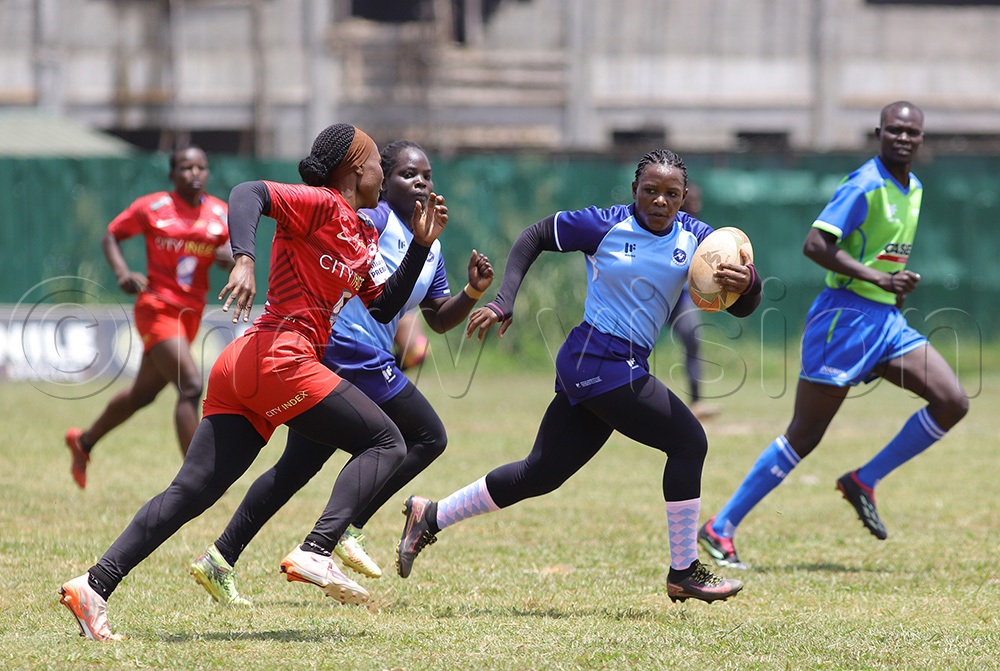 Thunderbird's Grace Nabaggala with the ball breaks through the Walukuba Titans opponents to score a try during the Gulu 7s. (Photo by Johnson Were)