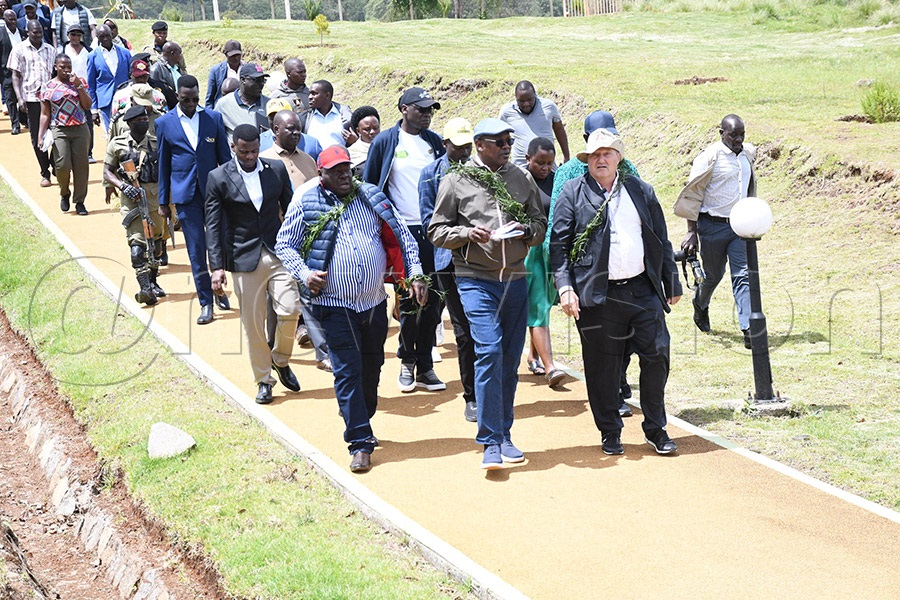 NCS Patrick Ogwel (left) and Presidential Advisor Gunter Lange lead MPs on a guided tour alongside the running track at the Teryet High Altitude Training Centre in Kapchorwa. Photo by Michael Nsubuga