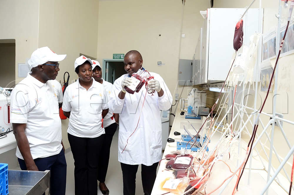 L&ndash;R: Daniel Mukasa Ddamulira, District Governor-Elect for Rotary District 9214; Rotarian Cynthia Baitwa; and Rotarian Florence Mukiibi listen as Swaib Kasuba, Laboratory Manager at Uganda Blood Transfusion Services, explains the process of handling donated blood during the launch of the Rotary Mega Blood Donation Drive at the Nakasero Blood Bank on Friday, June 26, 2026. (Photo by Lawrence Mulondo)