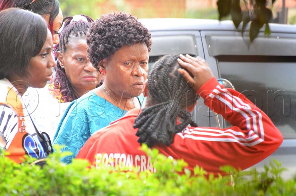  Douglas Mayanja's mum, Prossy Mayanja (2nd R), interacting with Sandra Teta's sister at Kabalagala Police on Thursday. (Credit: Stuart Yiga)