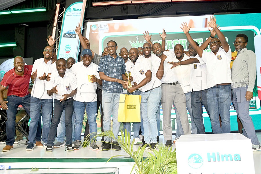 SMACK almunai celebrate as they receive their runners up trophy from the Attorney General Kiryowa Kiwanuka (sixth left) after the Clash of the Titans Golf tournament at Entebbe Club, last year. Photo by Michael Nsubuga