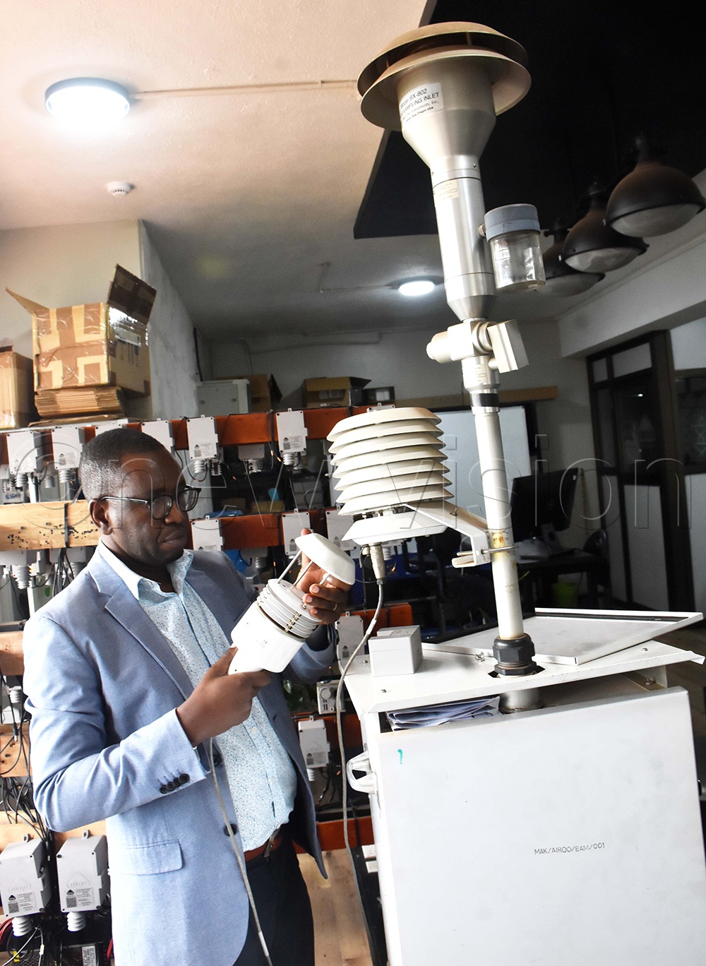 Makerere University Professor Engineer Bainomugisha holds part of a high-grade air-quality monitor that works alongside low-cost sensors. (Photo by Gerald Tenywa)