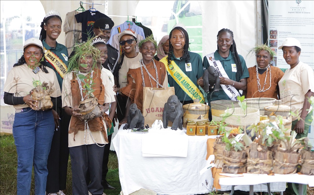 Miss Tourism, Miss Environment and Miss UWA catching a photo moment with the Batwa and Bakiga of Bwindi, who attended the wildlife day celebrations in Entebbe municipality on Tuesday.