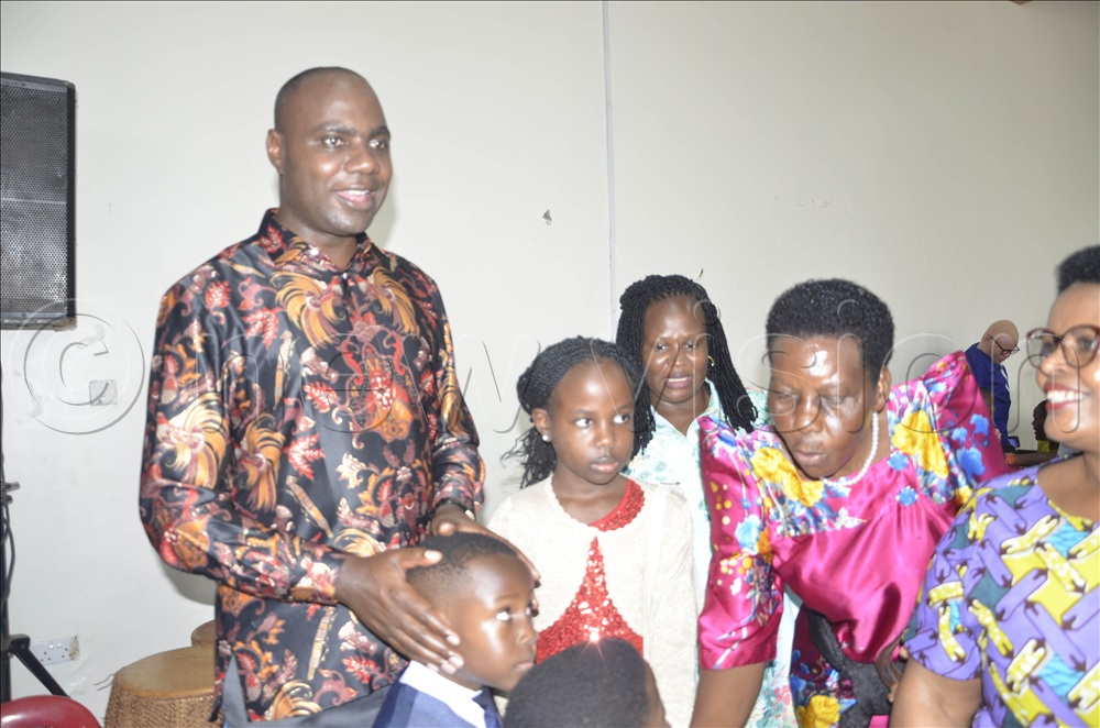 State Minister for Finance, Henry Musaasizi chating with Christians at St Padre-Pio Parish, Kabulamuliro, after the Easter Mass on Sunday, April 5, 2026.