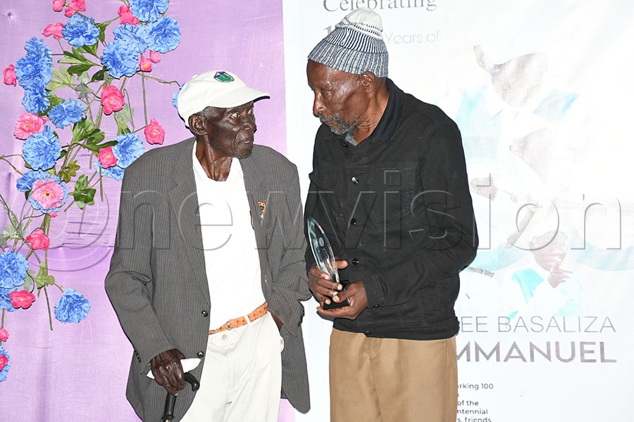 Emmanuel Basaliza (left) presents a trophy to Shasha Mwine who was the overall winner of the Basaliza Centennial Golf Tourmament at Tooro Golf Club, December 20, 2025. Photo by Michael Nsubuga