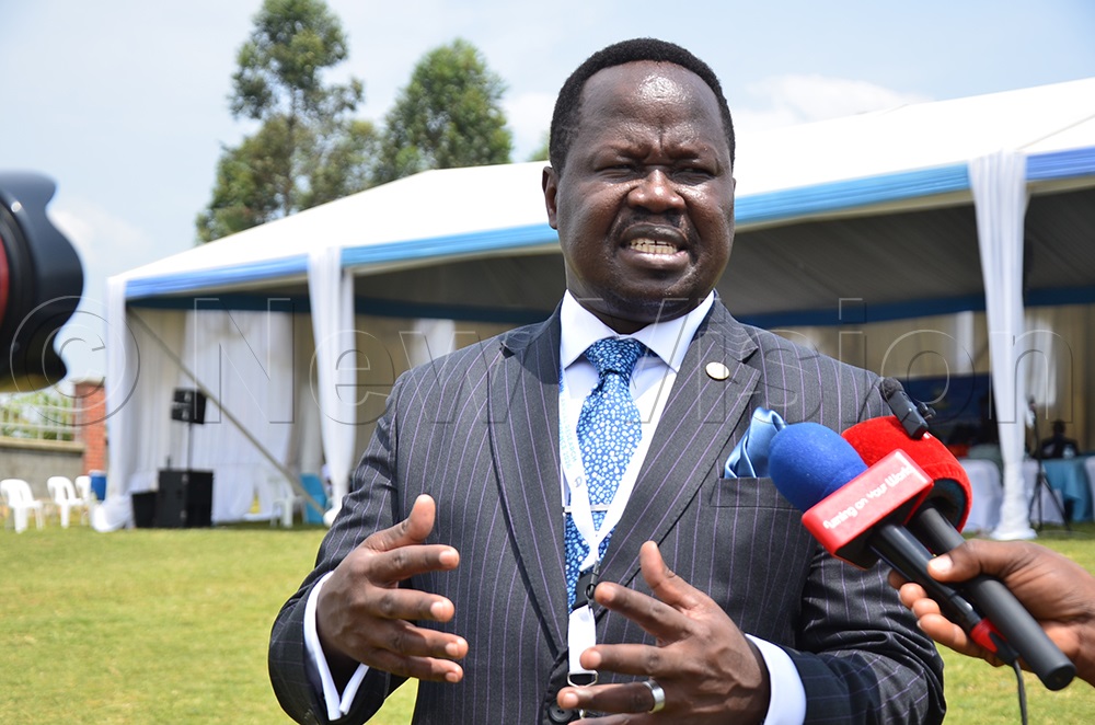 Francis Ogwang speaks to journalists following the research conference. (Photo by Jonan Tusingwire)