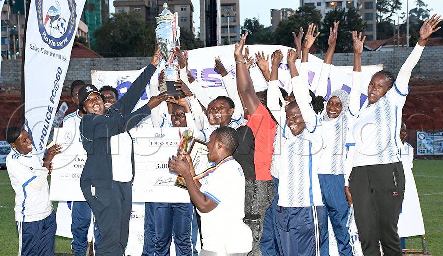 The director welfare, production and sports AIGP Hadija Namutebi (3rd left) awards the ICT Netball team with the IGP Cup after the second edition championship at the at Kira Road Police Arena. Photo by Michael Nsubuga