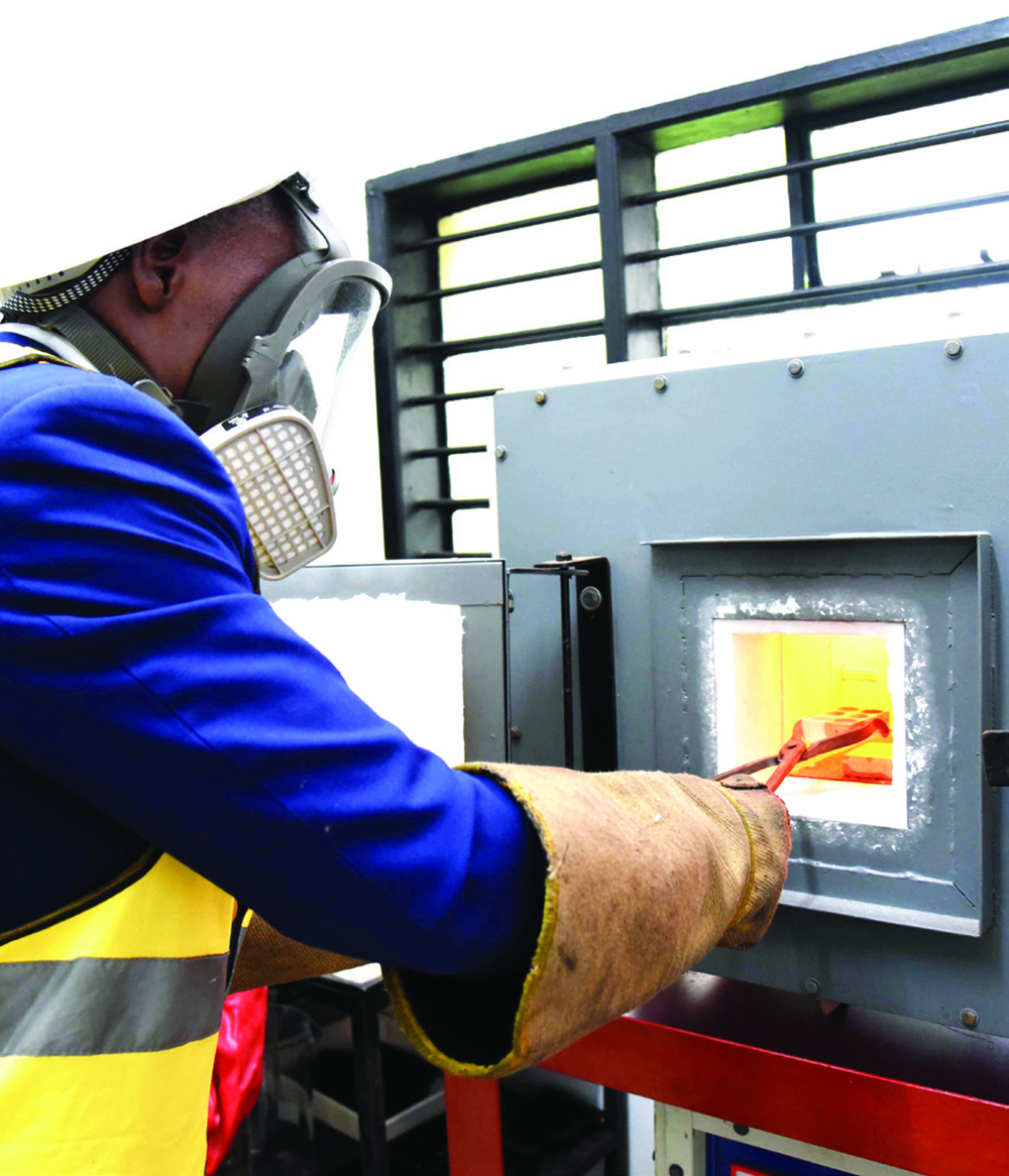 An employee operates a furnace at the facility. (File)