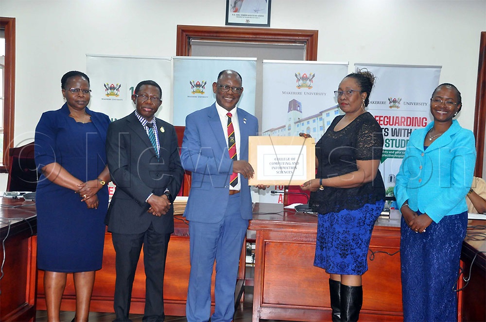 Makerere University Vice-Chancellor, Prof. Barnabas Nawangwe, in a group photo with some University officials. (Credit: John Odyek)