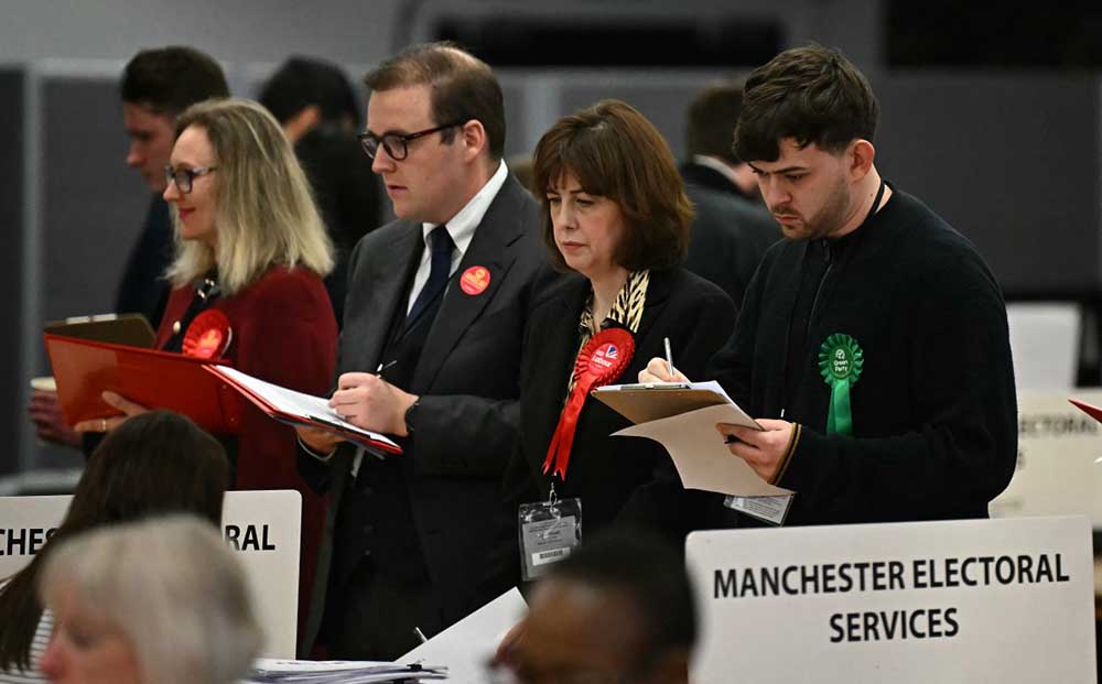Deputy labour party leader, Lucy Powell stands with observers from other parties as votes are counted after polling for the Gorton and Denton By-election closed, at the count and declaration event at Manchester Central Convention Complex in Manchester, northern England on February 26, 2026. (Credit: AFP)