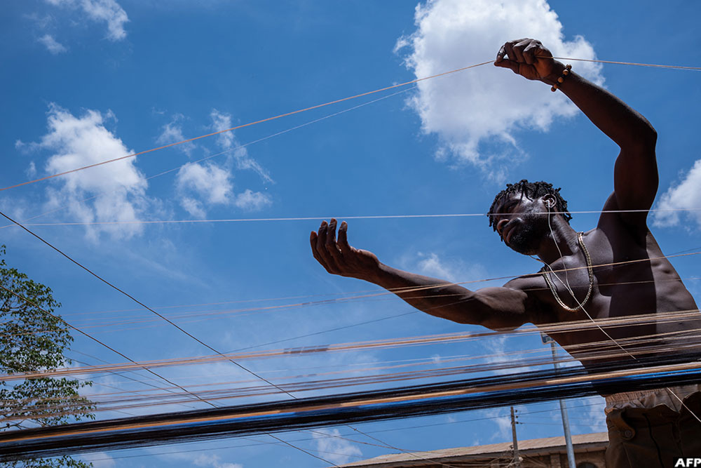 Waliu Fransisco separates tangled thread used for aso-oke