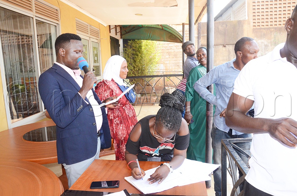 Ivan Okecho, the Electoral Commission returning officer at Pepsi Cola village, reads out the winner of LC.I elections, declaring Samuel Aliku as the overall winner on Tuesday, July 28, 2026. (Photo by Isaac Nuwagaba)