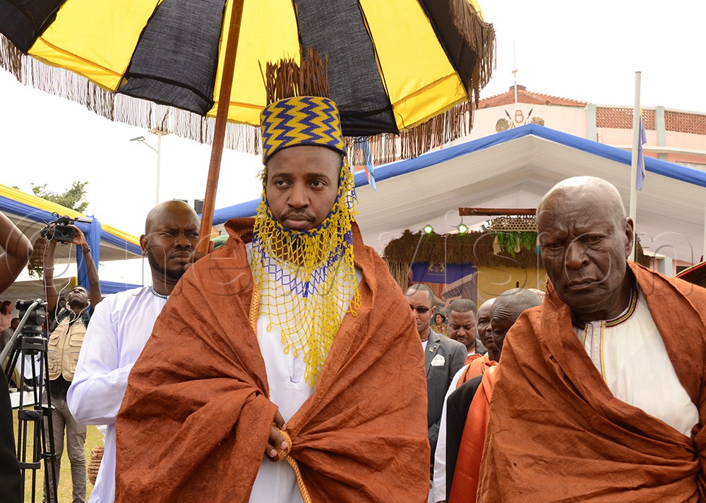 King Oyo flanked by his Uncle Charles Kamurasi performing some of the Empango rituals. (New Vision Archives)