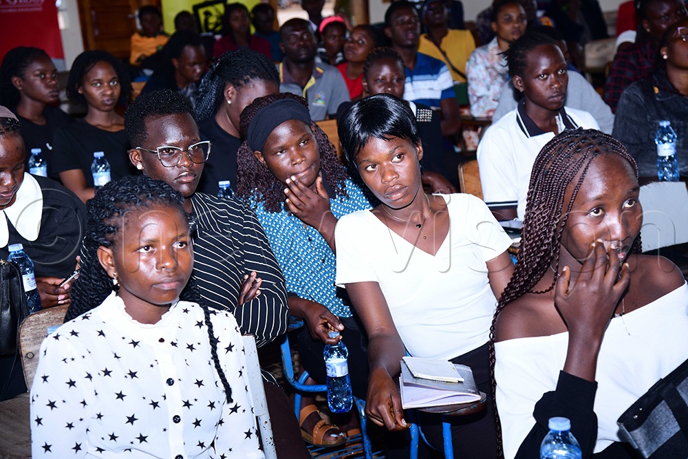 Gulu University students rewacthing the replay of the second season contest which they won. (Photo by Godfrey Ojore)