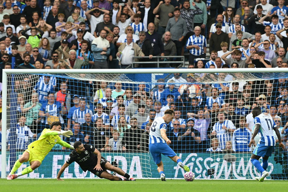 Brighton's German midfielder #08 Brajan Gruda (C) scores their second goal during the English Premier League football match between Brighton and Hove Albion and Manchester City at the American Express Community Stadium in Brighton, southern England on August 31, 2025.