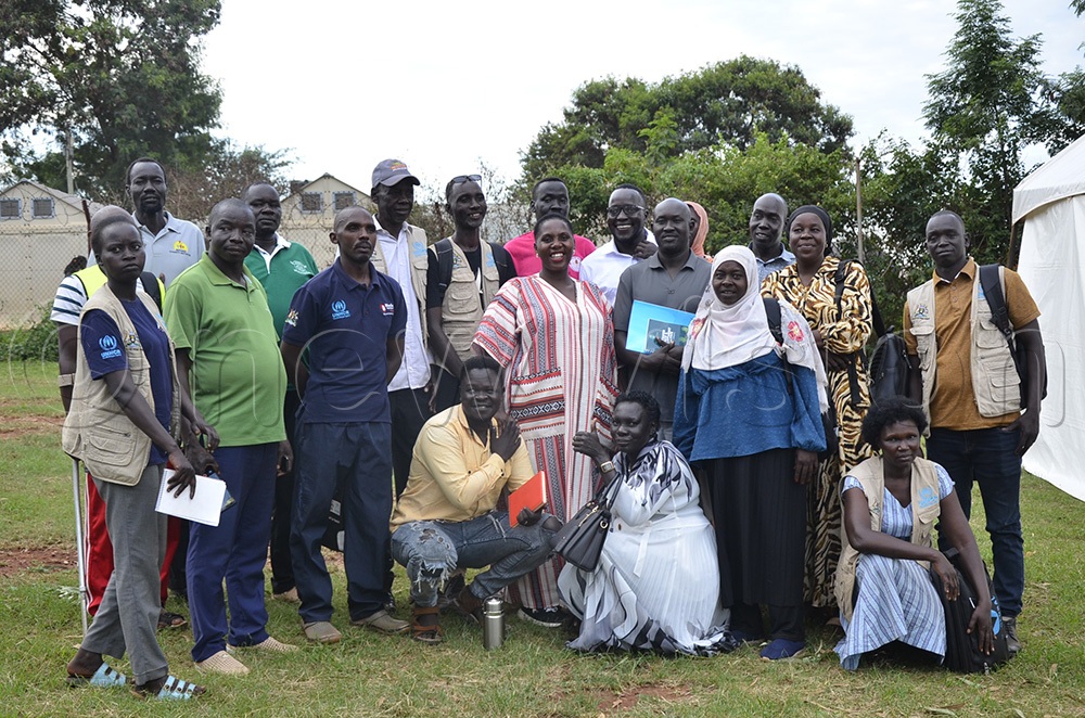 Jovia Katusiime, the woman MP for Kiryandongo District, in a group photo with the refugees' leaders. (Photo by Yosam Gucwaki)