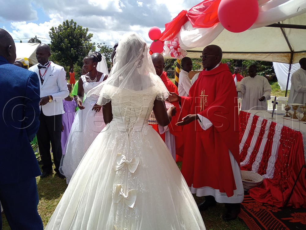 Two couples, Stephen Ochom and Harriet Audo, and Simon Peter Amechu and Margaret Amulen, exchanged wedding vows on Martyrs Day, Wednesday, June 3, 2026. (Credit: Christine Itado)