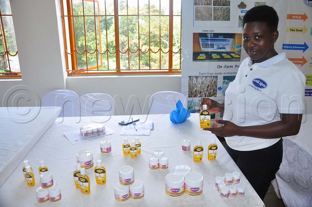 Raphaelina Okoth a student from Mbarara University of Science and Technology (MUST) exhibiting cosmetics made from ghee during the ‘Reimagining Higher Education for a Skills-Based, Innovation-Led Economy’ workshop and exhibition held at the College of Engineering, Makerere University. (Credit: John Odyek)