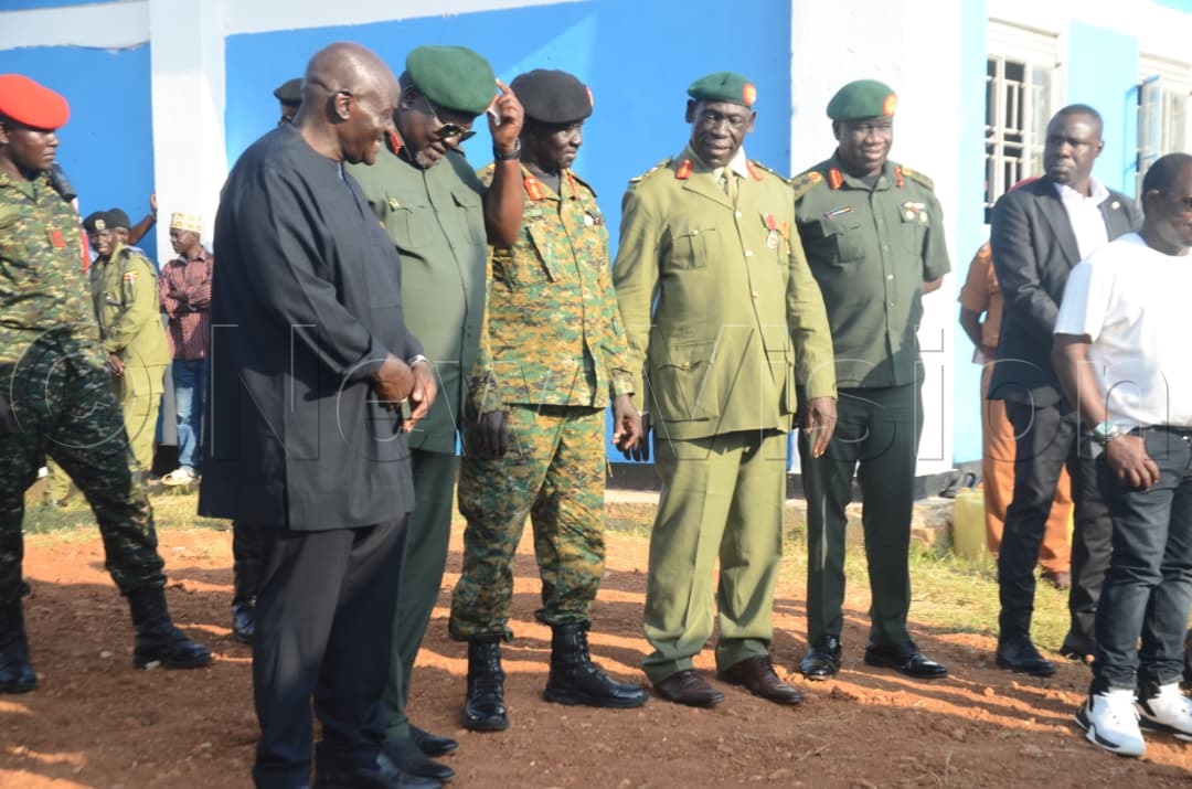 Former Chief of Defence Forces (CDF) Gen. Katumba Wamala (left) with other UPDF officers at the burial site.