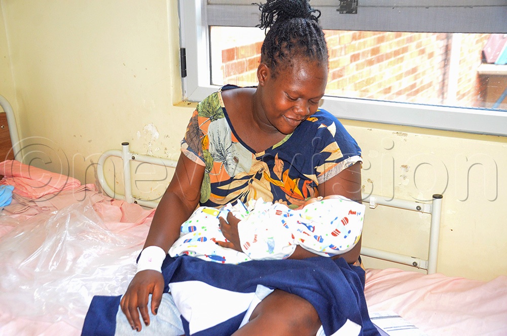 Hadija Nakato, smiling at the sight of her baby girl at Yumbe Regional Referral Hospital in Yumbe district. (Photo by Adam Gule)