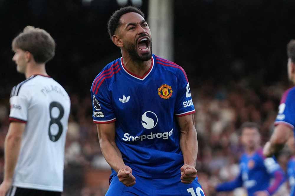 Manchester United's Brazilian striker #10 Matheus Cunha celebrates after his deflected shot makes it 1-1 during the English Premier League football match between Fulham and Manchester United at Craven Cottage in London on September 20, 2026. (Credit: AFP)