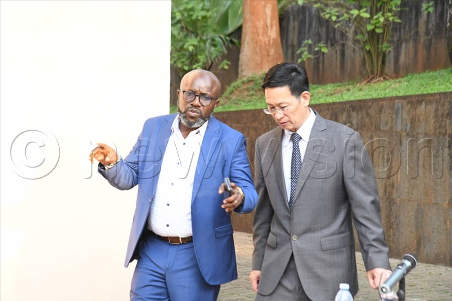 Vision Group Chief Executive Officer Don Wanyama interacts with Ambassador Zhang Lizhong.