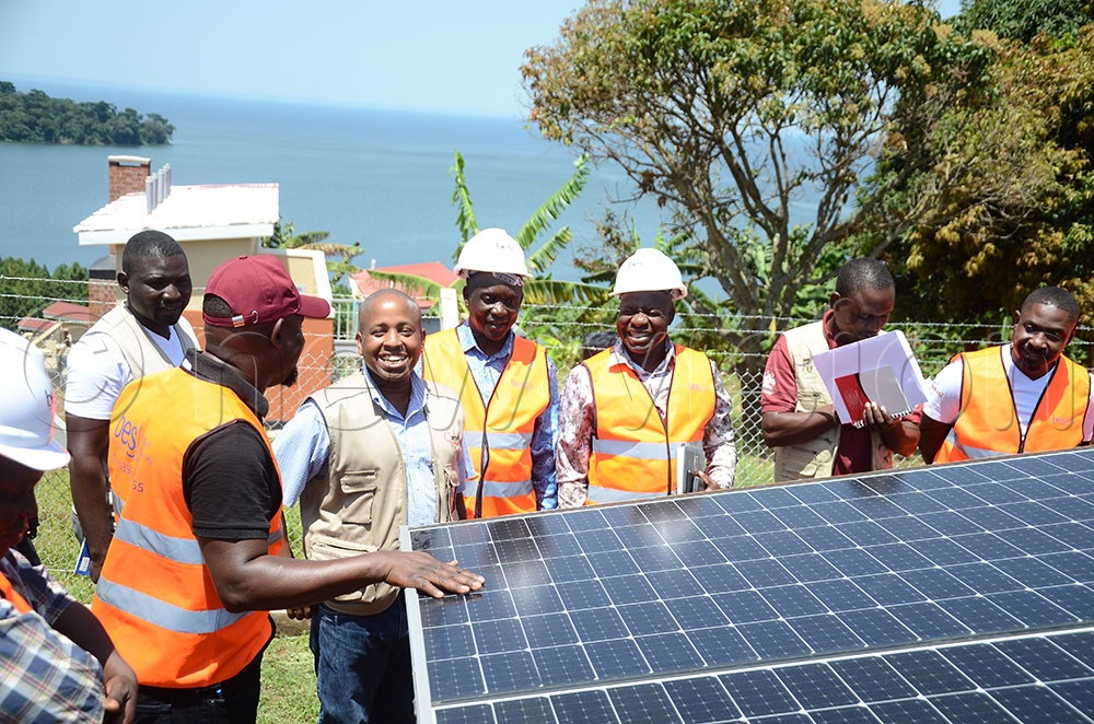 Eng. Andrew Kizito (red cap) explaining about the water system pump situated at St. Victor Mulabana primary school to Dr. Patrick Kagurusi (second from left), the Country Manager Amref Health Africa Uganda, Fred Badda (third from left), the Kalangala Resident District Commissioner, Richard Ssebandeke (fourth from left), the Chief Administrative Officer and other officials. This was during a joint supervision of activities and infrastructure under the Heroes for Gender Transformative Action program in Kalangala district on February 4, 2026. (Credit: Lawrence Mulondo)