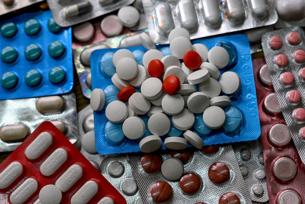 This photo illustration shows different medicines kept together, in Kolkata on August 27, 2025. Indian exporters on February 3 hailed Donald Trump's announcement of a US-India trade deal and a pledge to slash tariffs on the nation's goods. (Photo by Dibyangshu SARKAR / AFP)