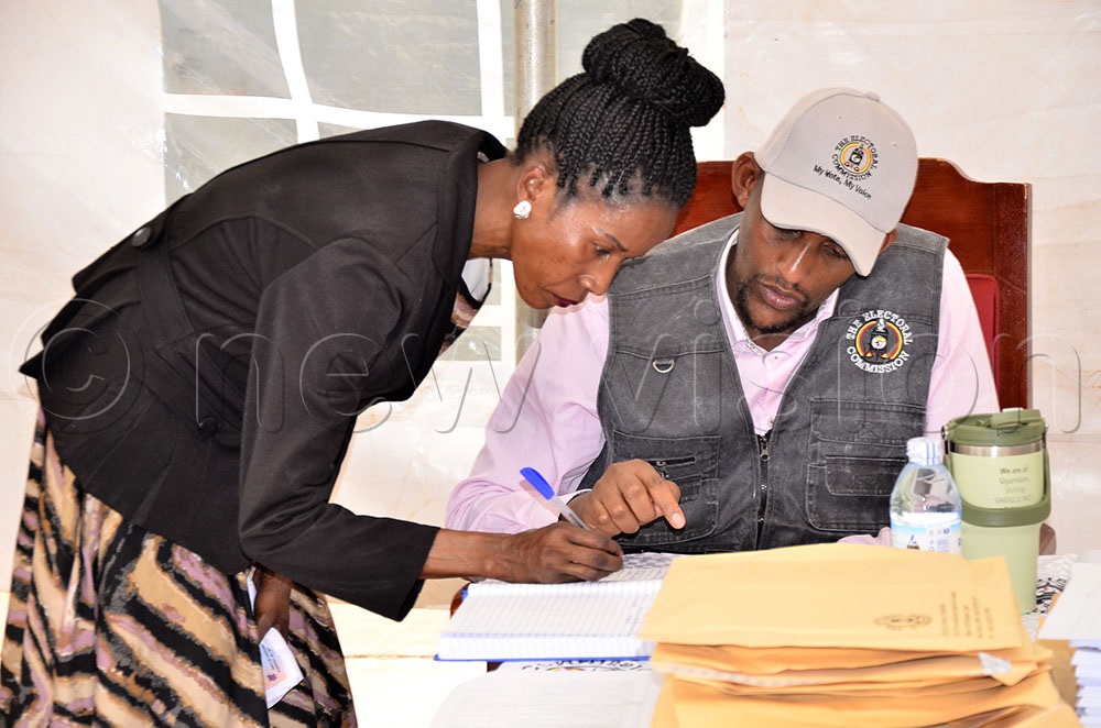 Susan Kwagala registering herself before being given an envelope containing copies of the presidential nomination forms. (Photo by Ronnie Kijjambu)