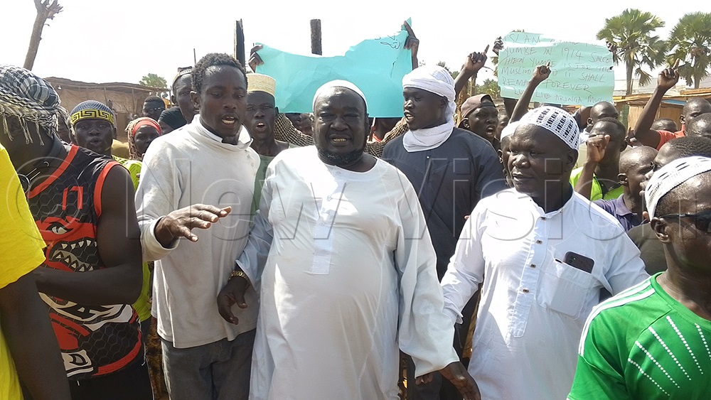 Hajji Kassim Abdallah (centre) being accompanied by the Muslims as they were heading home. (Photo by Adam Gule)