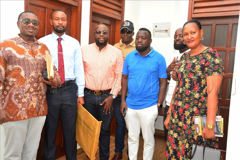 The chairman of the business community, Gideon Kirumira (left) pose for a group photo with fellow entrepreneurs
