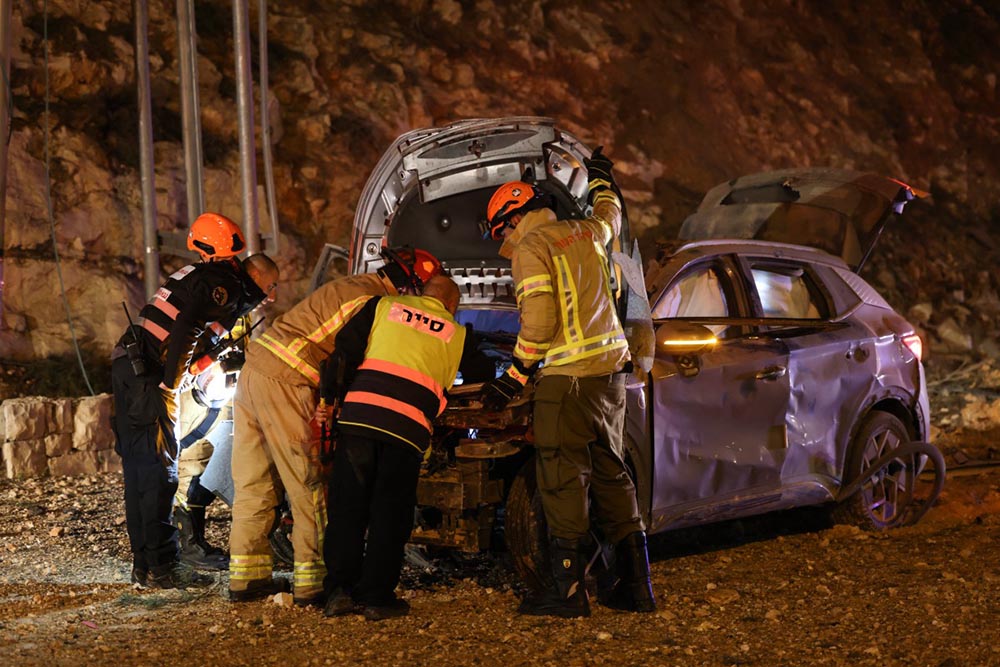Israel security forces inspect a damaged car after a missile struck a road in Jerusalem on March 1, 2026. The United States and Israel launched strikes against Iran on February 28, killing Iran's supreme leader and top military leaders, prompting authorities to retaliate with strikes on Israel and US bases across the Gulf. (Credit: AFP)