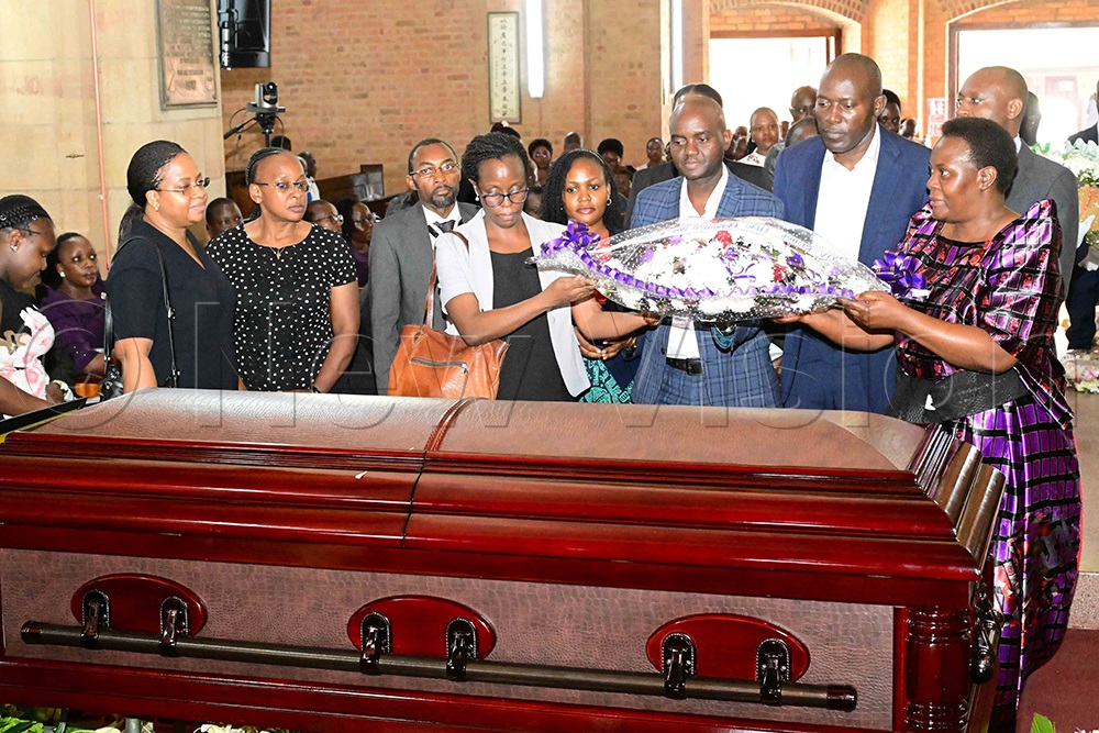 Some mourners lay wreaths on the coffin during the funeral service for the late Bishop Christopher Ssenyonjo. (Credit: Eddie Ssejjoba)