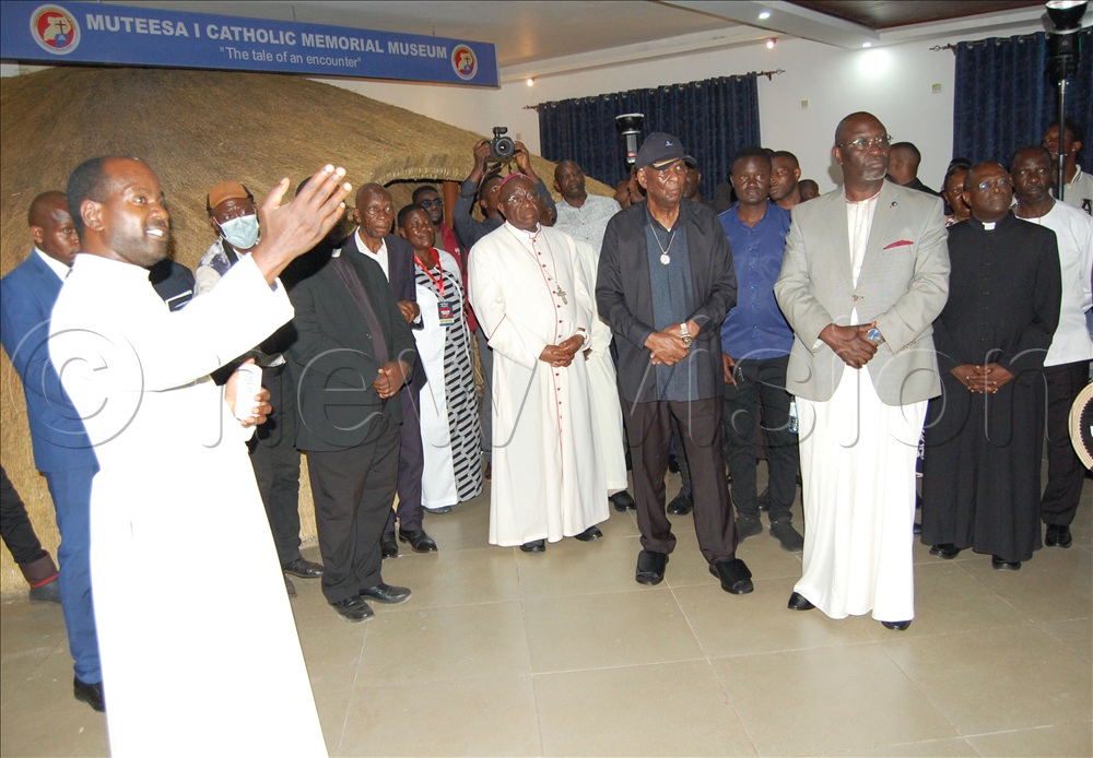 Fr. Dr. John Vianney Kitooro (left) takes visitors through a guided tour of Kabaka Muteesa I Catholic Memorial Museum during its commissioning on October 25.