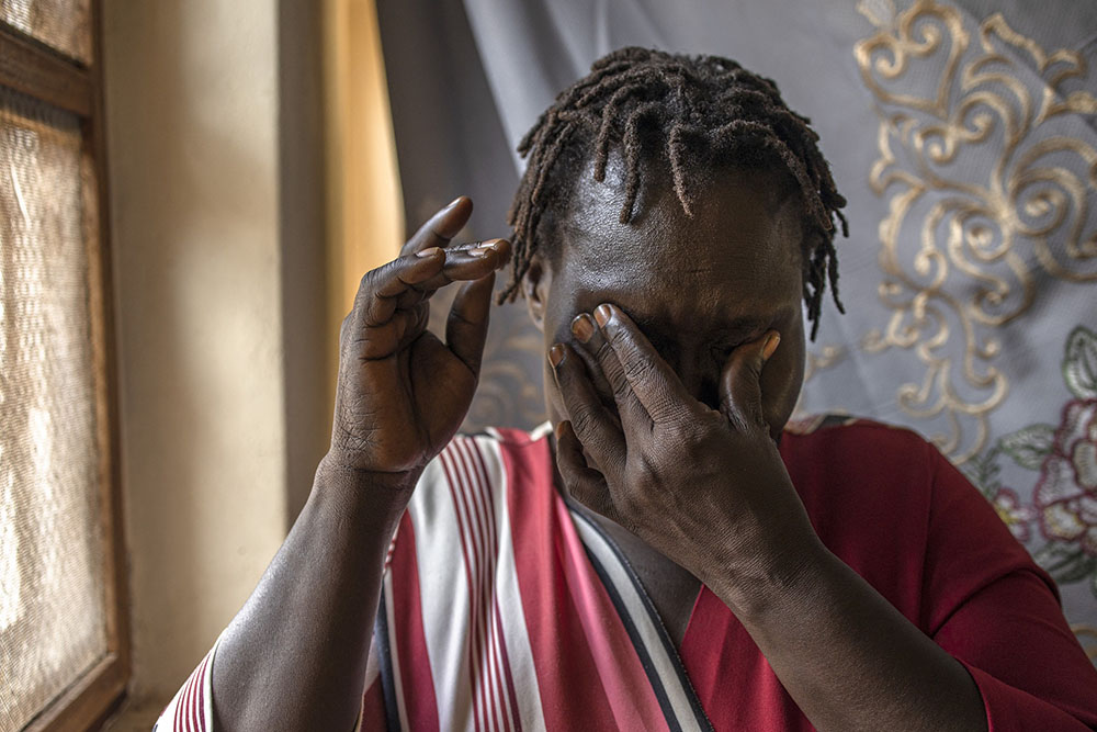 Florence Akello, 37, who spent 13 years in captivity with the Lord’s Resistance Army (LRA), breaks down in tears at the War Victims and Children Networking Initiative office in Gulu, on September 4, 2025. (Credit: AFP)