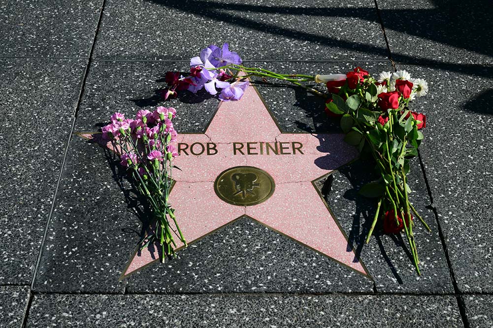 Flowers are left at US actor and director Rob Reiner's Star on the Hollywood Walk of Fame in Los Angeles, California, on December 15, 2025. Reiner's son was charged with murder, police said on December 15, after his father and mother were found dead the previous day in their Los Angeles home. (Credit: AFP)