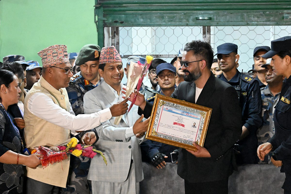 Rastriya Swatantra Party (RSP) election candidate Balendra Shah (centre R) meets supporters after collecting a certificate following his victory in parliamentary elections at the counting centre in Damak in Nepal's Jhapa district on March 7, 2026. Nepal's rapper-turned-mayor Shah grinned and flashed a V for victory sign on March 7 as Election Commission officials confirmed he had defeated veteran leader KP Sharma Oli in their parliamentary constituency. 