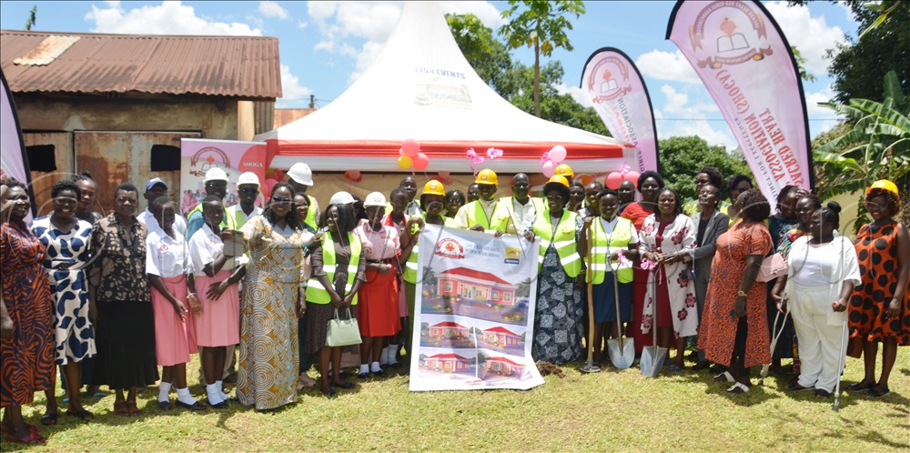 SHOGA and students’ representatives post for a photo with Monsignor Rev. Fr. Martin Agwee, the Vicar General of Archdiocese of Gulu and Betty Aol Ocan, woman MP Gulu city during the launch of construction of sick bay.